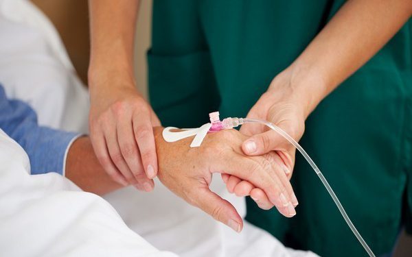 Female doctor checking patients pulse in hospital