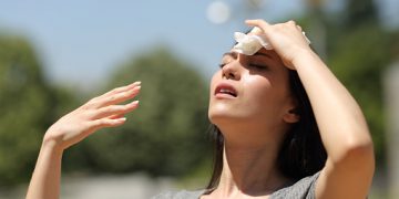 Asian woman drying sweat in a warm summer day