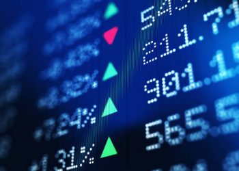 Financial data analysis graph showing stock market trends on a trading board. Horizontal composition with copy space and selective focus.