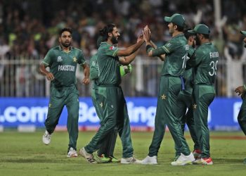 Pakistan's Imad Wasim, without cap, celebrates with teammates after the dismissal of New Zealand's Daryl Mitchell during the Cricket Twenty20 World Cup match between New Zealand and Pakistan in Sharjah, UAE, Tuesday, Oct. 26, 2021. (AP Photo/Aijaz Rahi)