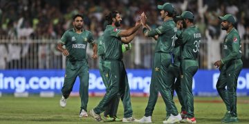 Pakistan's Imad Wasim, without cap, celebrates with teammates after the dismissal of New Zealand's Daryl Mitchell during the Cricket Twenty20 World Cup match between New Zealand and Pakistan in Sharjah, UAE, Tuesday, Oct. 26, 2021. (AP Photo/Aijaz Rahi)