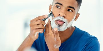 Shot of handsome young man beginning to shave his face