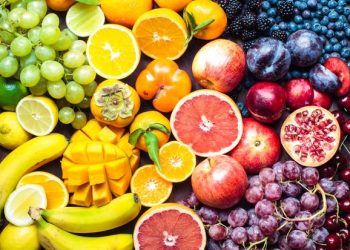 A colourful spectrum of fruit: oranges, lemons, limes, mandarins, grapes, plums, grapefruit, pomegranate, persimmons, bananas, cherries, apples, mangoes, blackberries and blueberries.