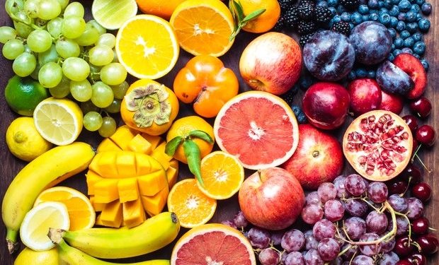 A colourful spectrum of fruit: oranges, lemons, limes, mandarins, grapes, plums, grapefruit, pomegranate, persimmons, bananas, cherries, apples, mangoes, blackberries and blueberries.