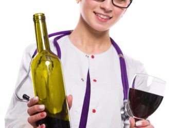 Young beautiful woman doctor with stethoscope offering wine in white uniform on white background